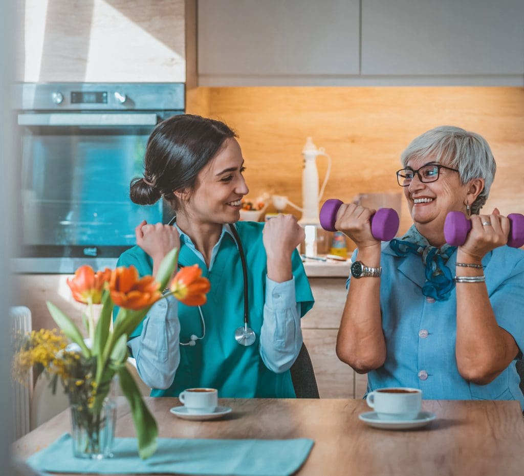 Elderly Woman and Rehabilitation Caregiver working on exercises