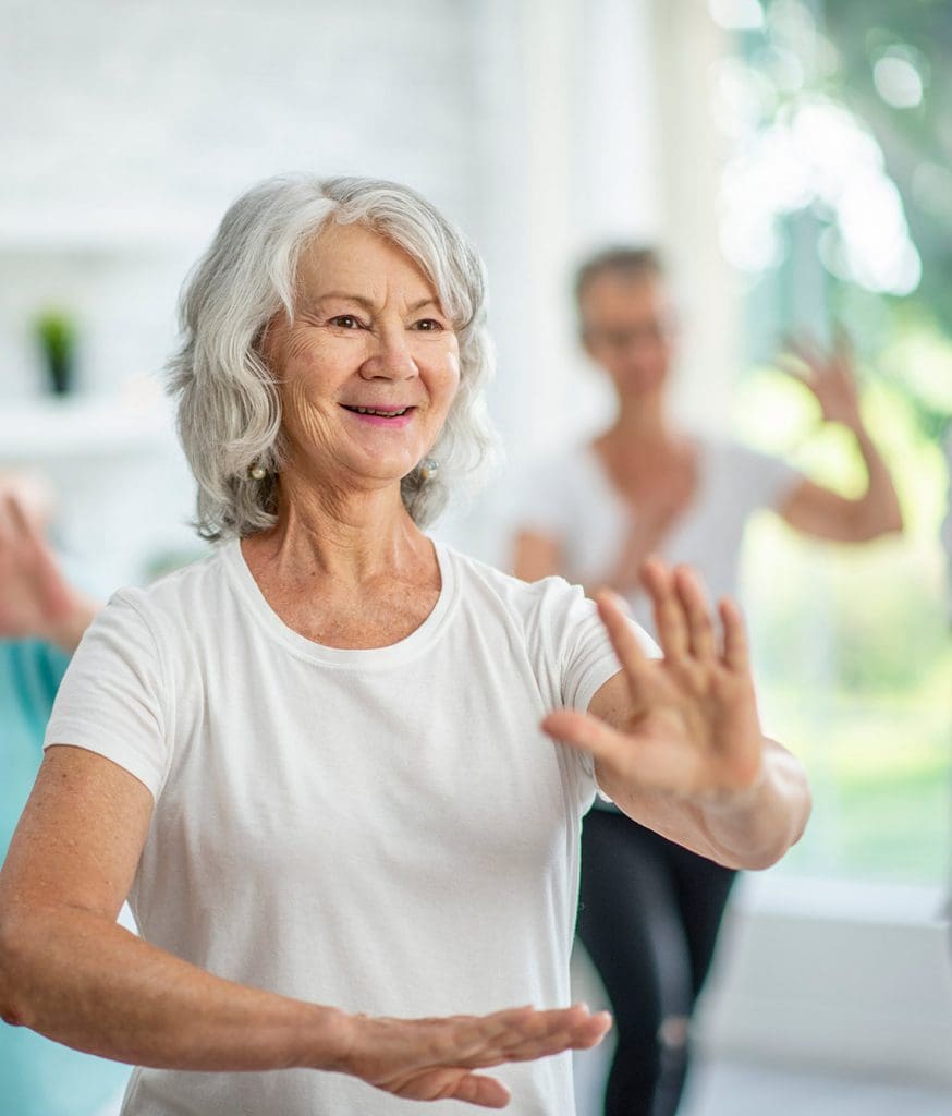 Retired Senior Woman taking page in an exercise class