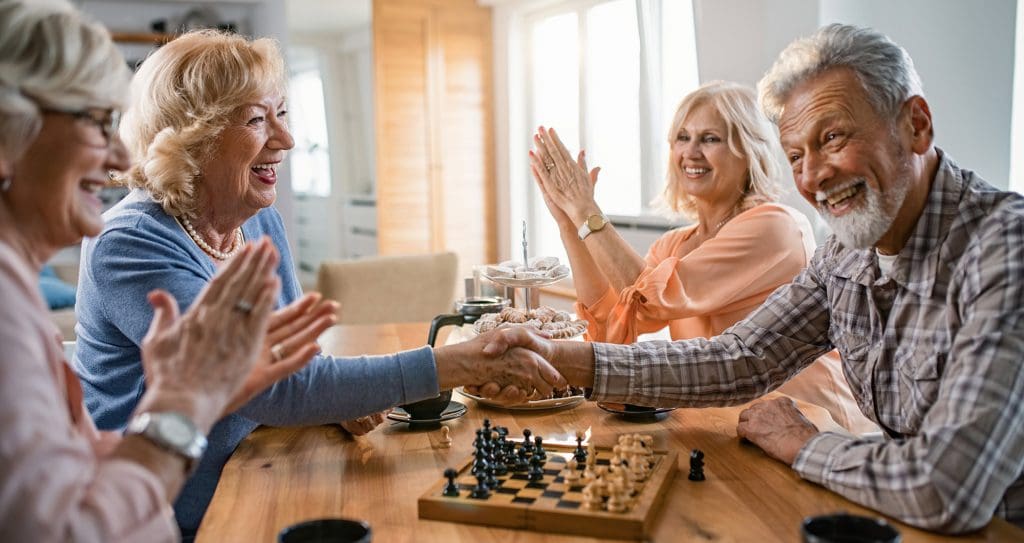 Four Peter Becker Community residents playing board games