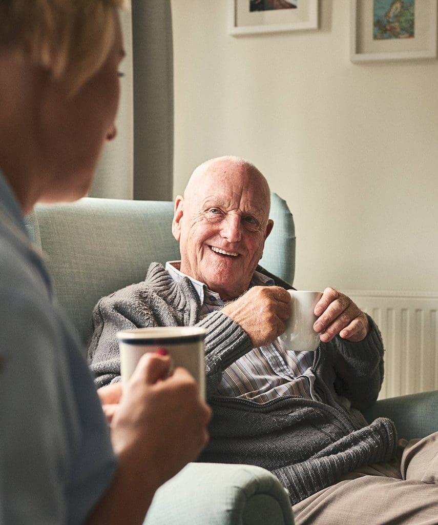 Senior aged man sitting in armchair