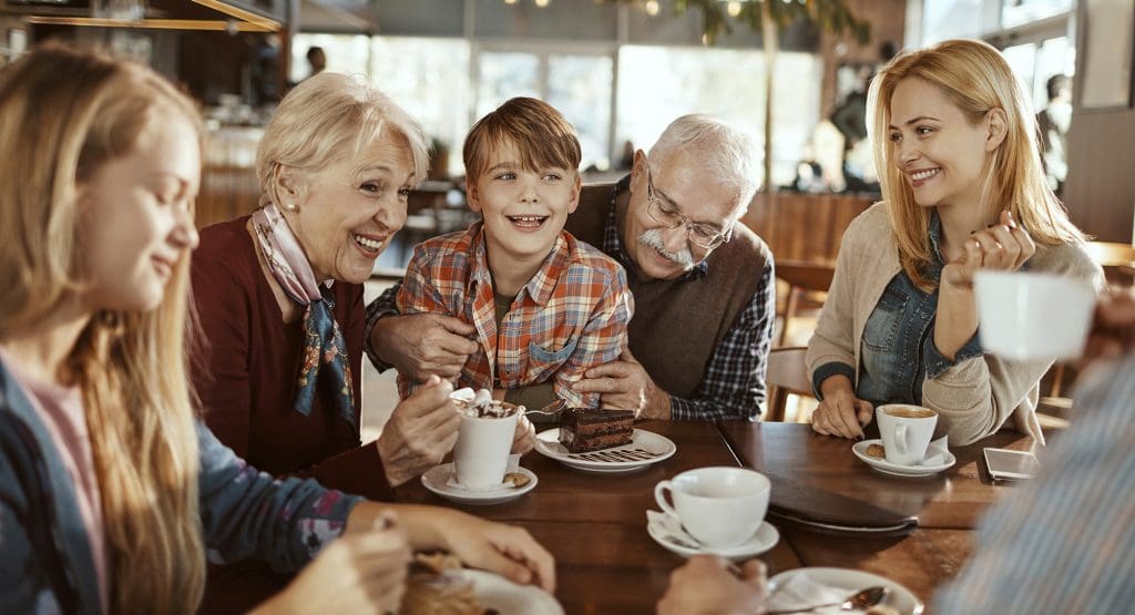 Residents and their families sitting around a table