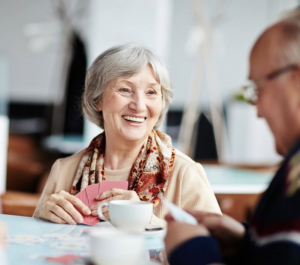 Senior Aged Woman Smiling at Male Companion