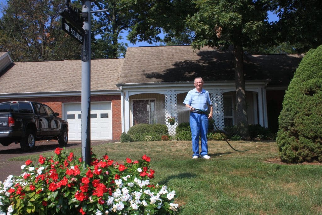 Peter Becker Community resident watering his yard