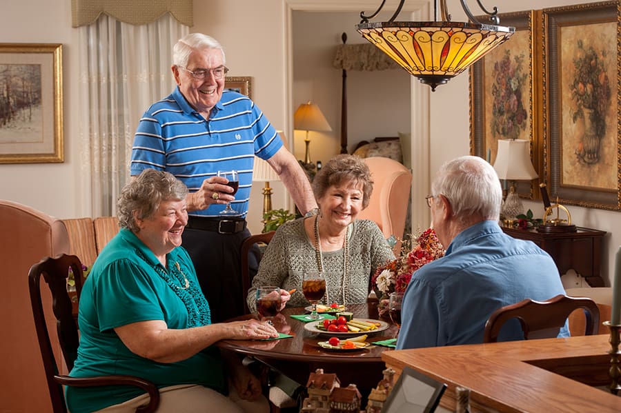 Peter Becker Community residents gather around a table for dinner