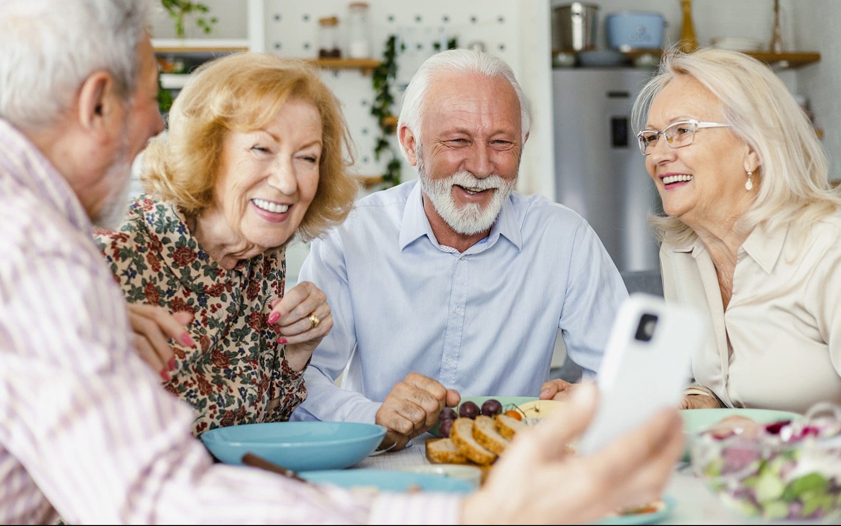 seniors gathered around a breakfast table talking