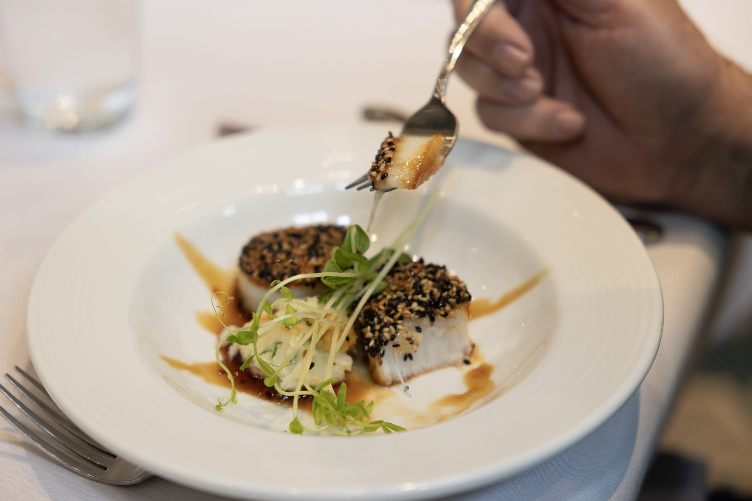 240-_C5A8988 Chef Plating Pan Fried Duck in the kitchen at Peter Becker Community