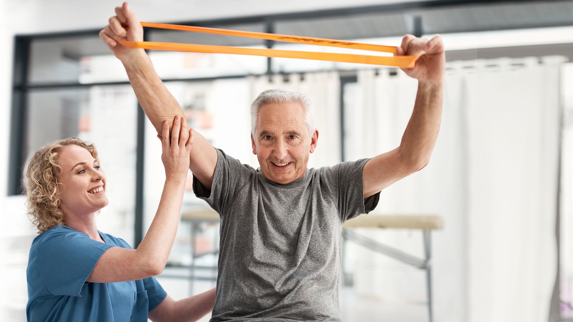 Shot of a nurse helping a senior man with physical therapy using a resistance band
