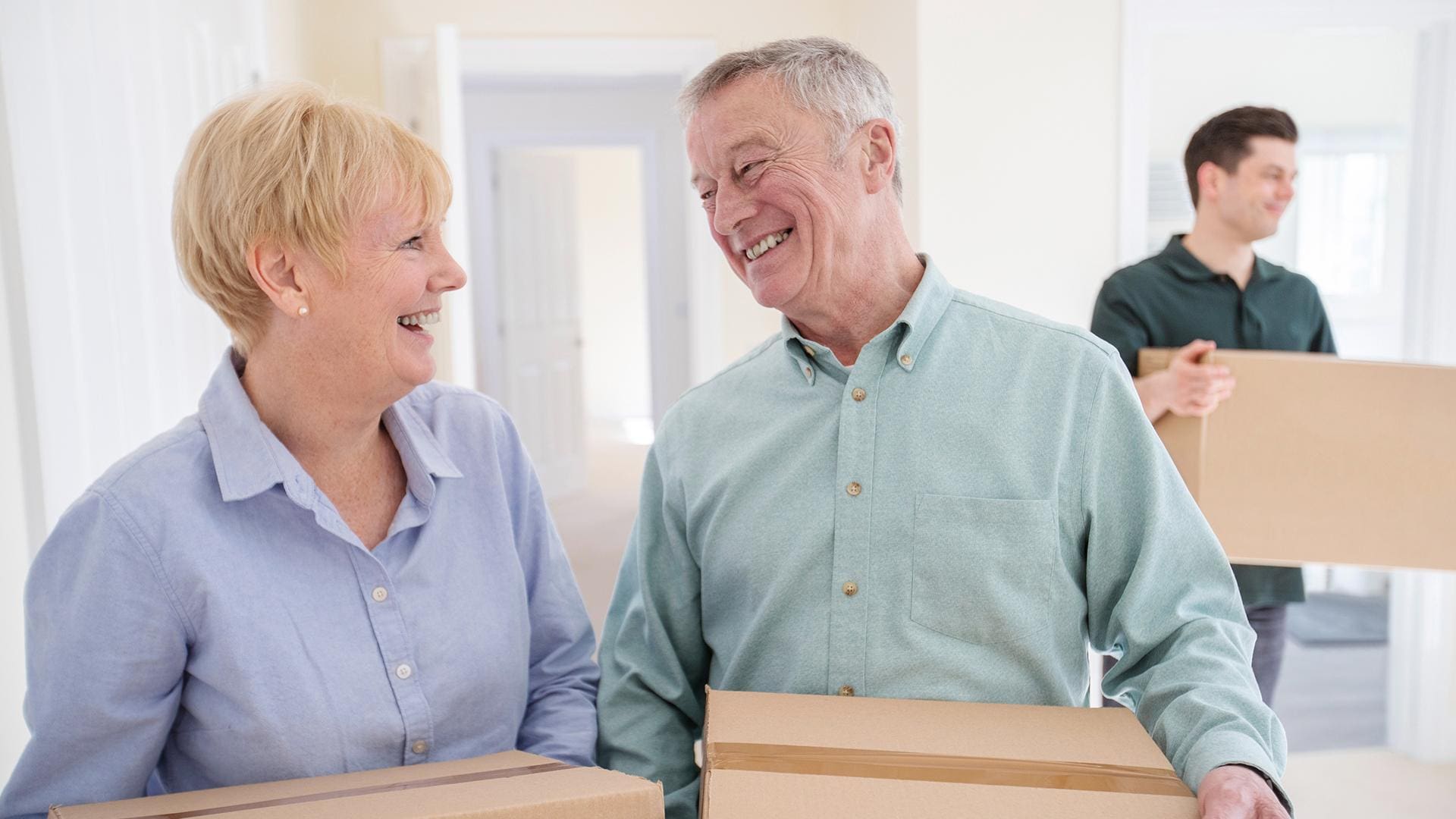 senior couple packing up for moving into senior living