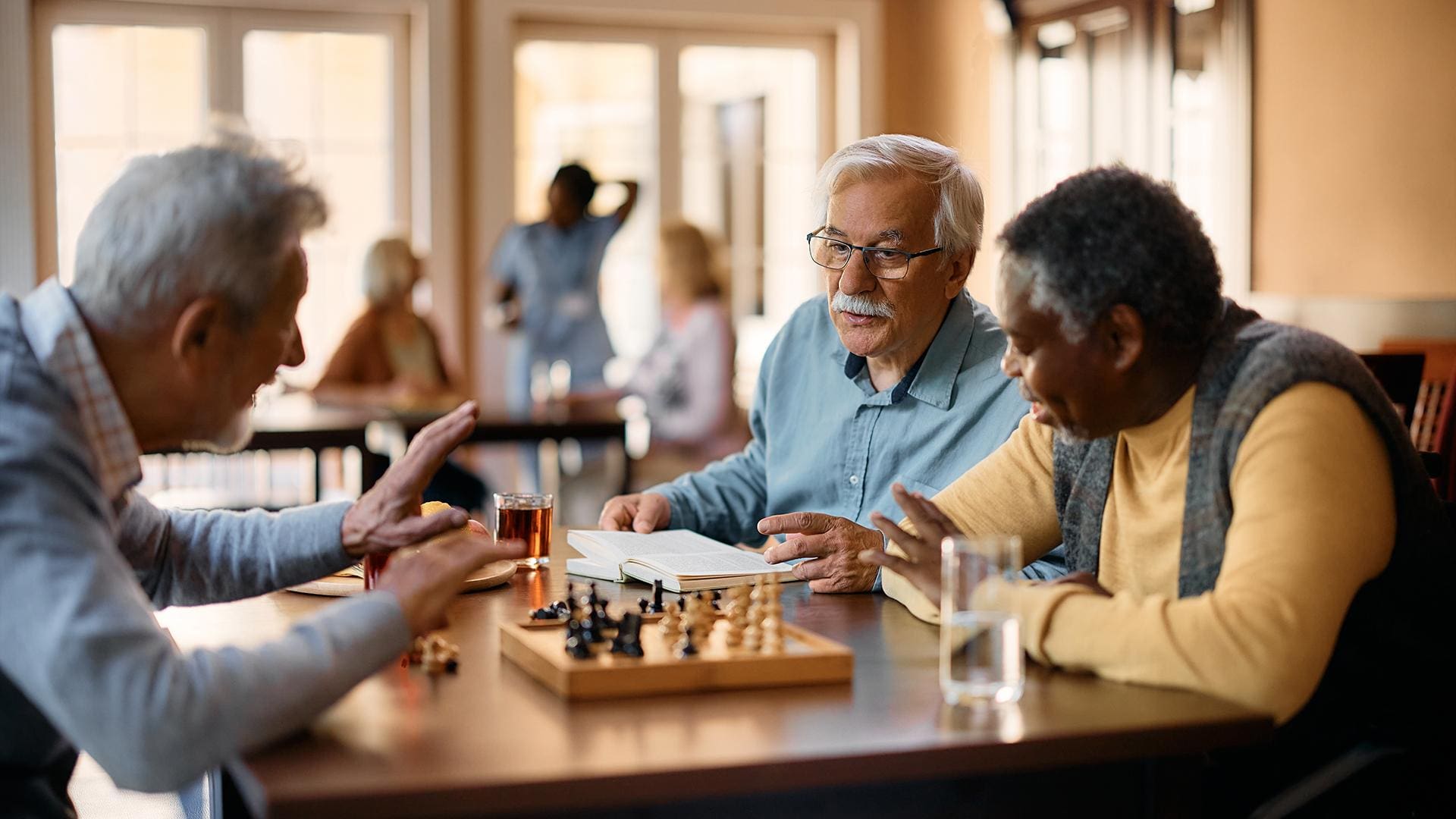 senior men in personal care playing chess
