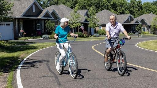 Seniors riding their bikes at peter becker community