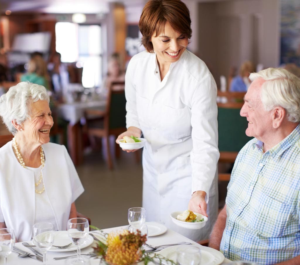 Senior Aged Woman Smiling at Male Companion