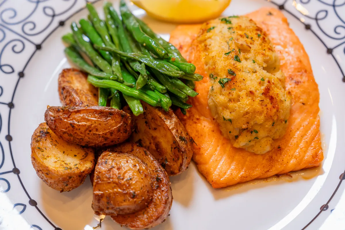 delicious-dining-salmon Senior woman in glasses reading book at home