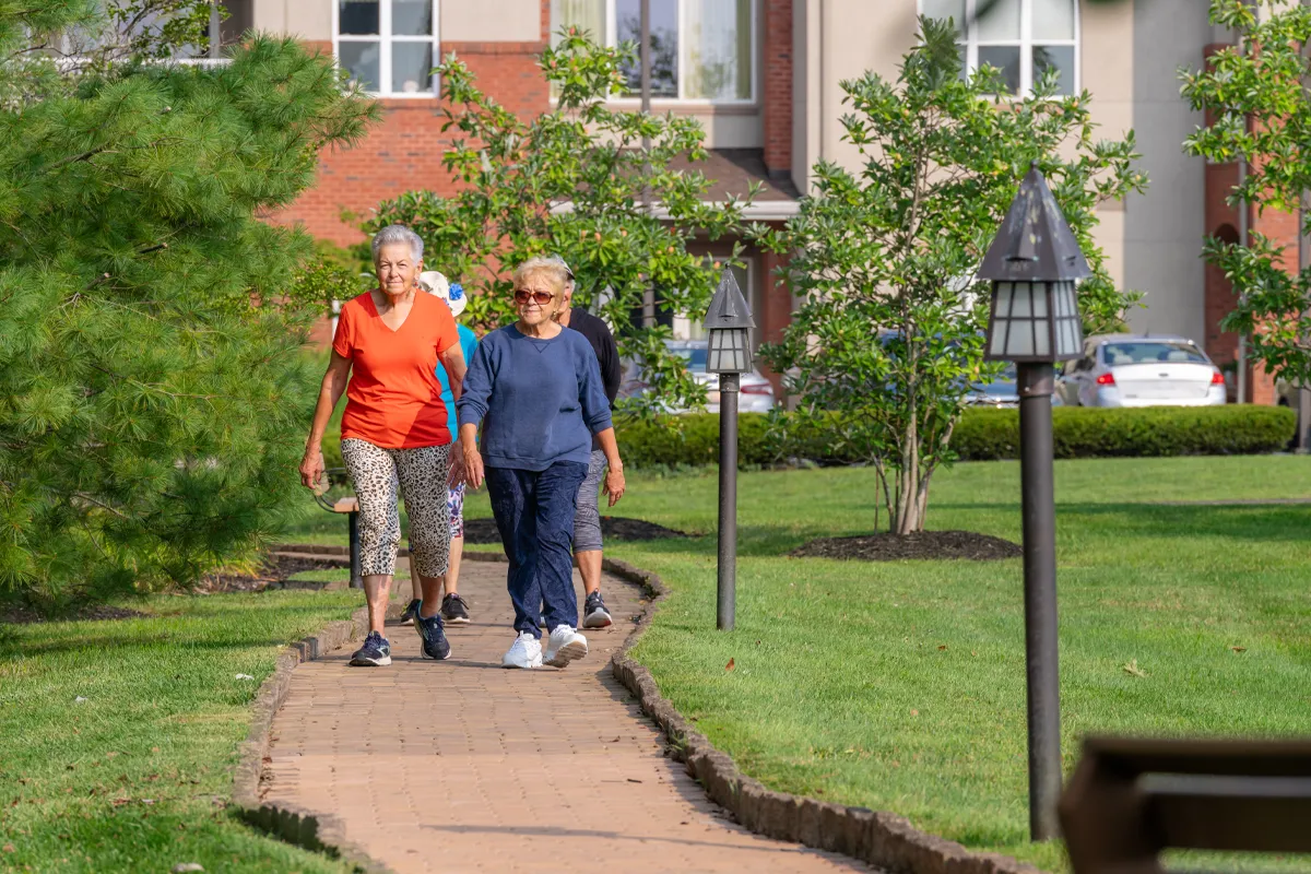 senior-group-walking Two retired seniors taking a brisk walk around Peter Becker Community