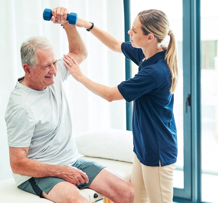 Caregiver handing a Senior-aged woman a cup of tea
